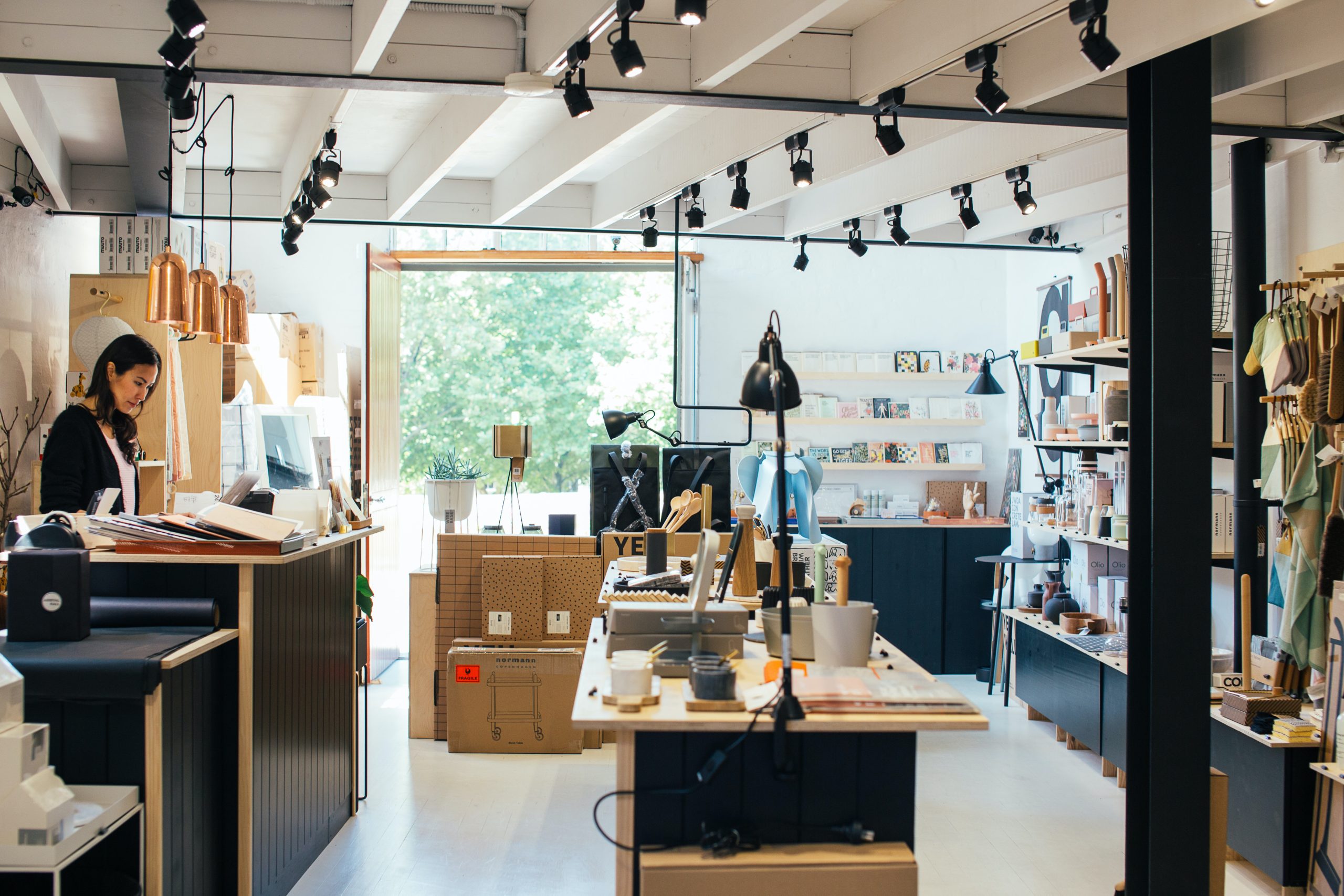 Inside of merchandise store with owner in background