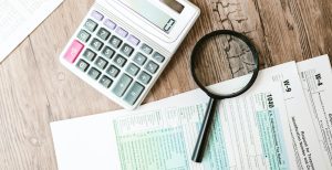 tax forms and calculator on a desk