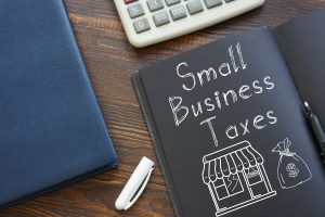 Small Business Taxes are shown on a business photo using the text