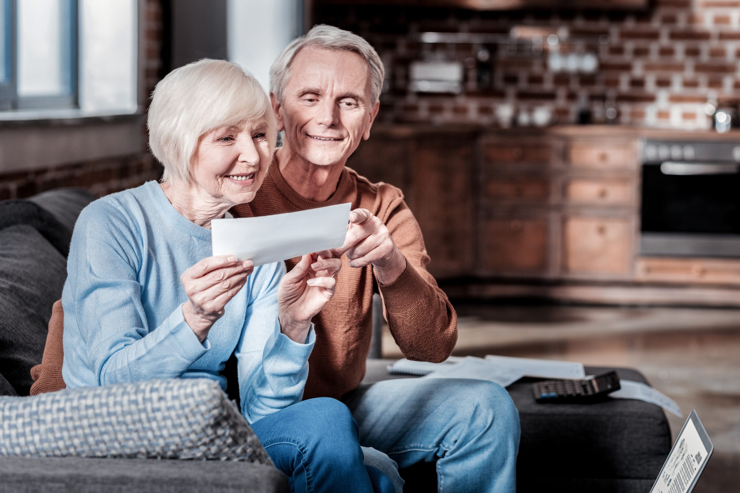 Good for you. Smiling male person embracing his wife while pointing at counting