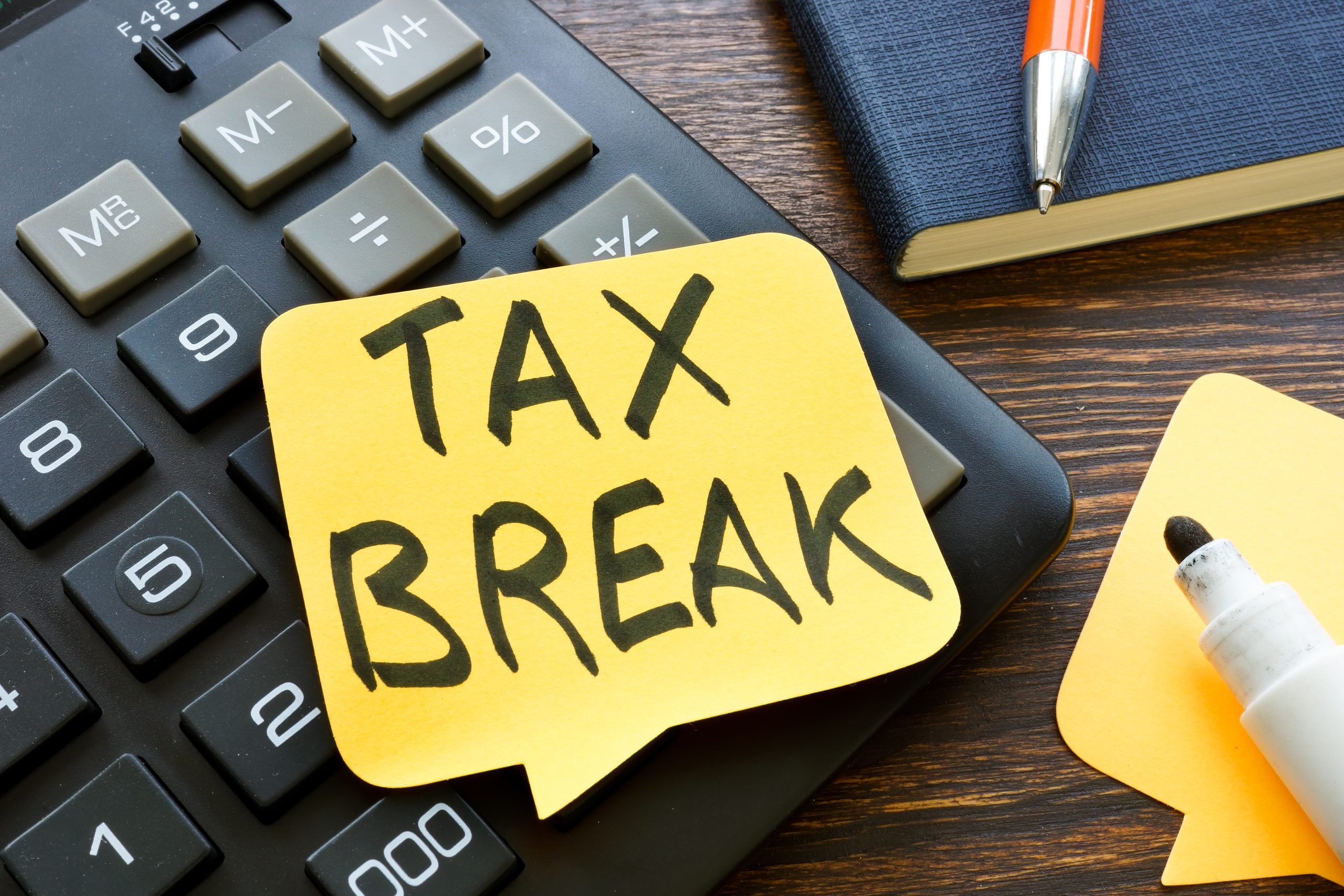 Tax break memo on the calculator and pen.