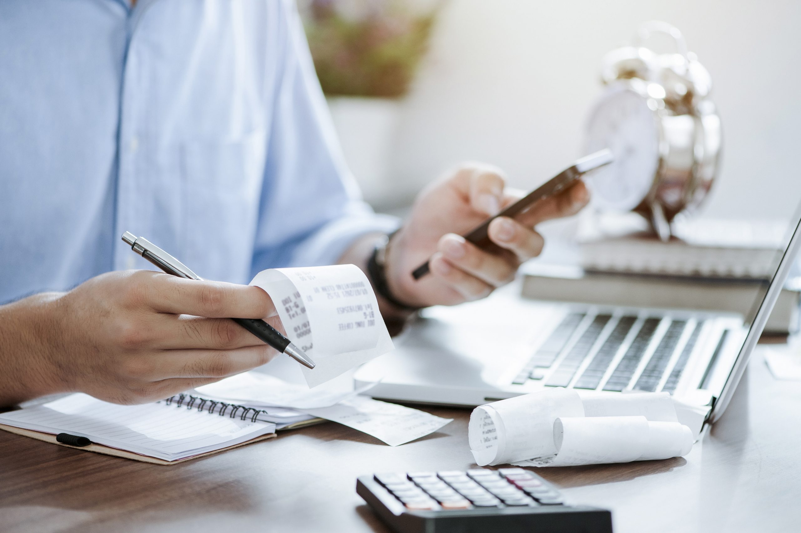 young man holding pen with bills working for calculate business data, taxes, bills payment, Start up counting finance. accounting, statistics, and analytic research concept