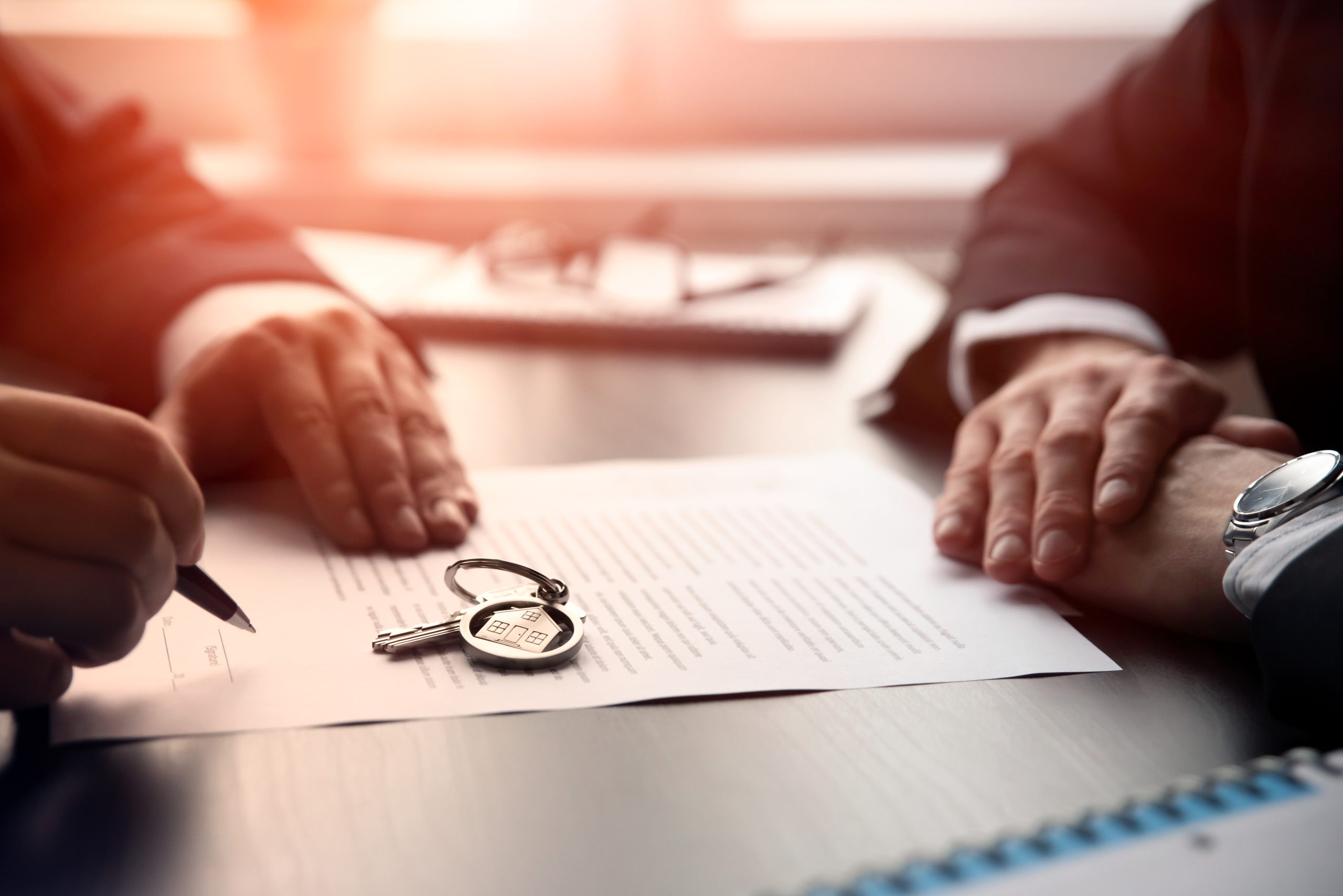 Real estate agent signing a contract buy-sell house. Two men sitting at the desk, home insurance policy on home loans, insurance agent concept